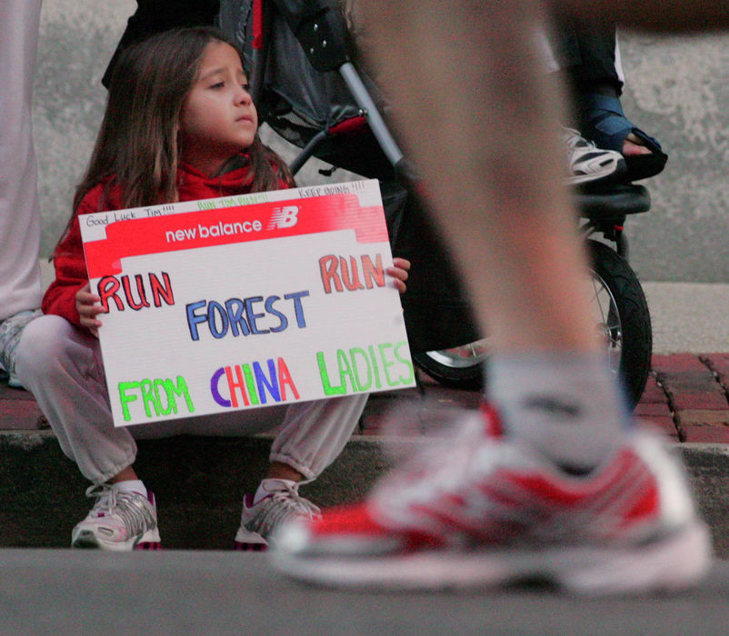 Award of Excellence, Team Picture Story - Bob DeMay / Akron Beacon JournalSix year-old Brisha Bohling from Munster, Indiana holds as sign while waiting to spot her dad Patrick Callahan who was running in the 5th annual Road Runner Akron Marathon in downtown Akron.