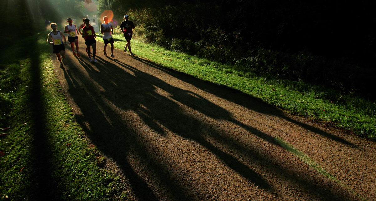 Award of Excellence, Team Picture Story - Ken Love / Akron Beacon JournalThe shadows of runners stretch ahead just after sunrise near mile 14 on the tow path bike trial at the 5th annual Road Runner Akron Marathon.
