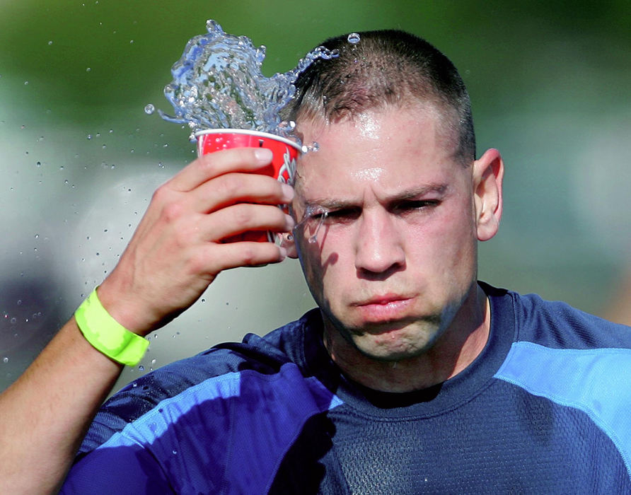 Award of Excellence, Team Picture Story - Phil Masturzo / Akron Beacon JournalRunning the fifth leg for The Procrastinators relay team, Kevin Deeter,  from Wadsworth cools off at the Market Street water station during the 5th annual Road Runner Akron Marathon.