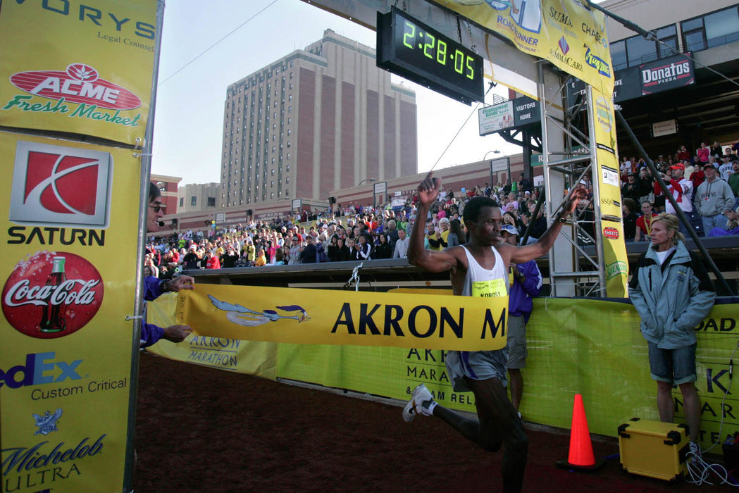 Award of Excellence, Team Picture Story - Bob DeMay / Akron Beacon JournalJoshua Koros crosses the finish line to win the 5th annual Road Runner Akron Marathon with a time of 2:28:05. Koros is originally from Kenya and now resides in Byron Center, Mich. 