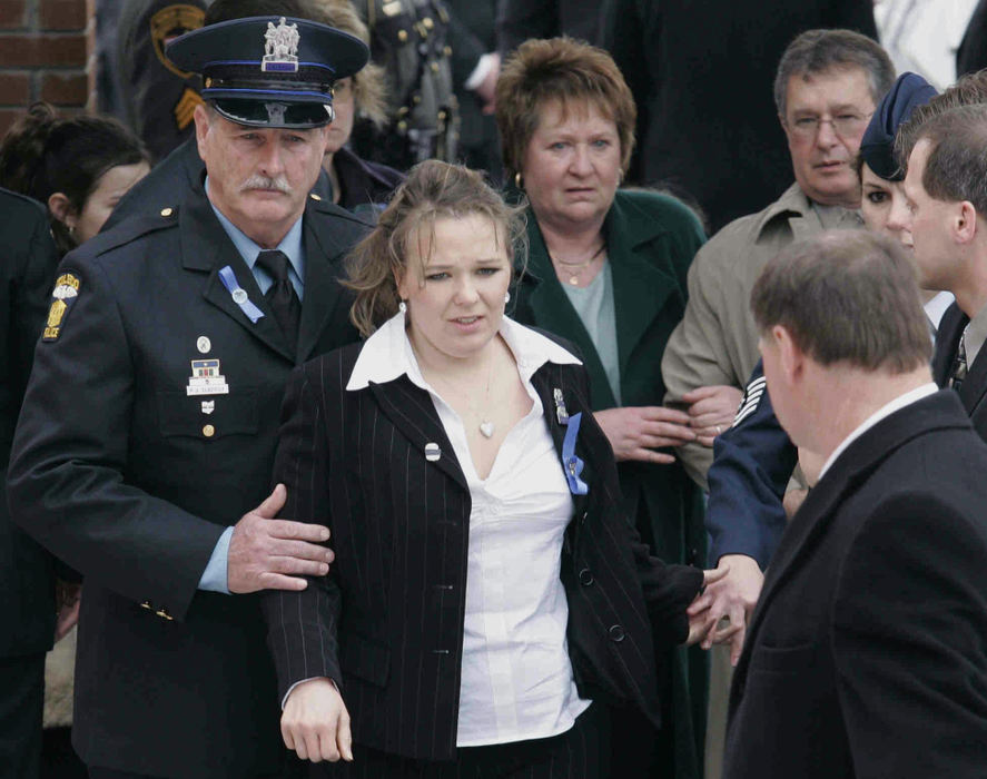 Award of Excellence, Team Picture Story - Dave Zapotosky / The Blade Officer Patrick  Gladieux (left) escorts Danielle Dressel, widow of slain Det. Keith Dressel from church following funeral mass, followed by  Larraine and Michael Dressel.