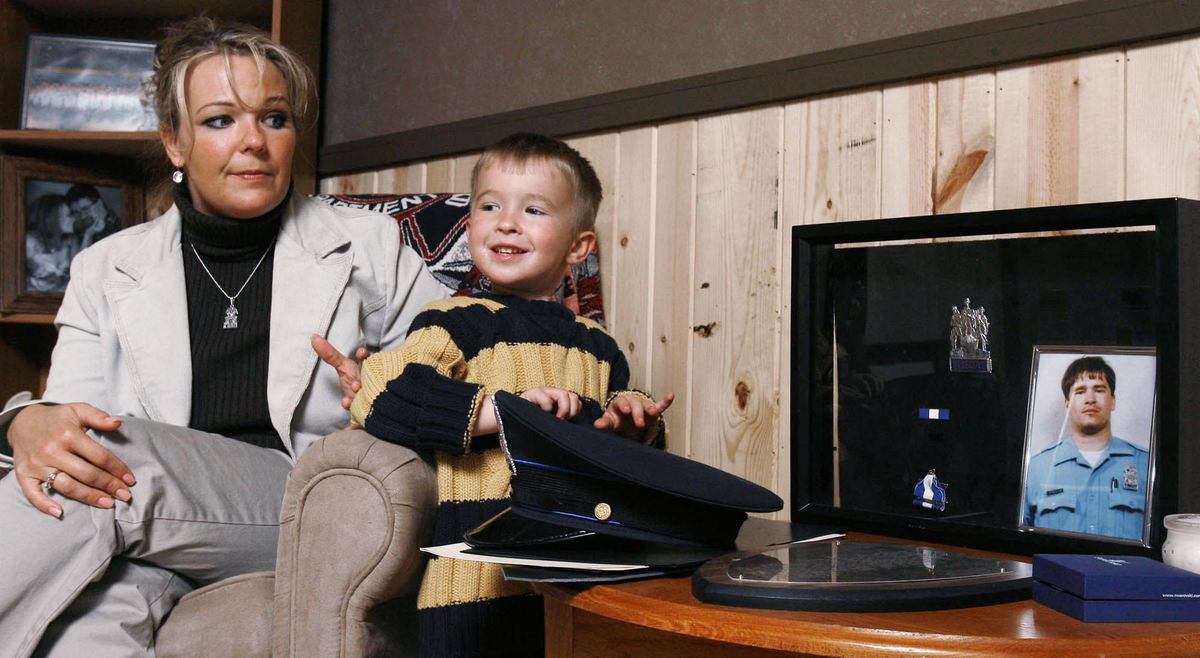 Award of Excellence, Team Picture Story - Jeremy Wadsworth / The BladeDanielle Dressel with her son Noah Dressel on  May 17, 2007 in Toledo. The widow of slain Toledo Police Vice Detective Keith Dressel, who was killed in the line of duty Feb. 21 in North Toledo. She just graduated from college and is raising two children.