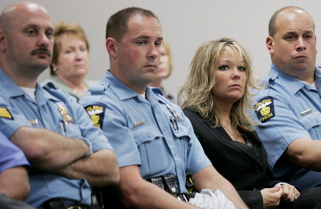 Award of Excellence, Team Picture Story - Dave Zapotosky / The BladeDanielle Dressel, widow of slain Toledo Police Detective Keith Dressel, listens to testimony with Toledo police officers. Fifteen-year-old Robert Jobe faces retired Lucas County Juvenile Court Judge James Ray today, accused of killing Detective Keith Dressel. Judge Ray ruled that Jobe can be tried as an adult.