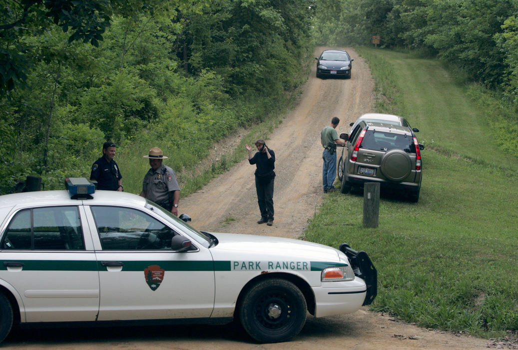 First Place, Team Picture Story - Phil Masturzo / Akron Beacon JournalPark rangers block the entrance to the Top O' the World area of the Hampton Hills Metro Park where Jessie Davis' body was found.