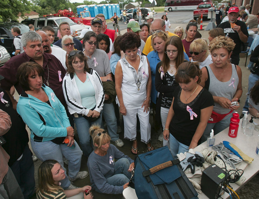 First Place, Team Picture Story - Phil Masturzo / Akron Beacon JournalSearch volunteers watch a live newscast announcing Bobby Cutts Jr. had been arrested and the bodies of Jessie Marie Davis and her unborn baby were found at the Top O' the World area of the Hampton Hills Metro Park some 25 miles away.