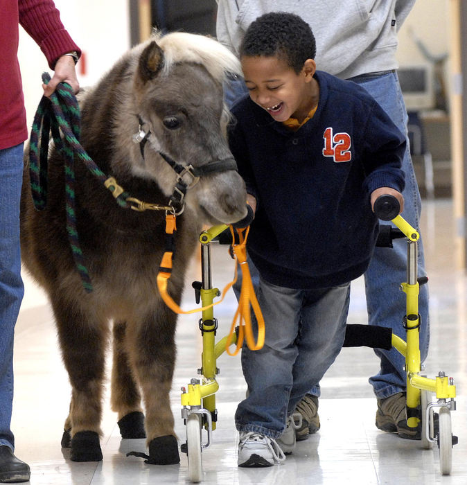 Award of Excellence, Feature - Marshall Gorby / Springfield News-SunRolling Hills Elementary kindergartener, Dominick Messer walks with Micah, a miniature therapy horse from DOGTORS & Associates in Springfield,  Nov. 20, 2008.  