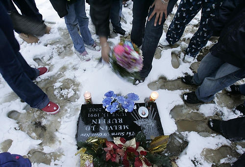 First Place, Feature Picture Story - Chris Russell / The Columbus DispatchLaDawnya Ruffin places a wreath on Melvin's grave as she and family members gather to mark the anniversary of his death almost one year after the killing. 