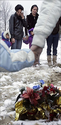 First Place, Feature Picture Story - Chris Russell / The Columbus DispatchLaDawnya Ruffin wipes a tear away while holding hands with her sister and two of her youngest children during a memorial for her son Melvin who was murdered almost one year from the day.