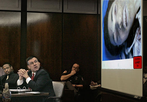 First Place, Feature Picture Story - Chris Russell / The Columbus DispatchA photo of Melvin Ruffin lying on the coroners table is projected in the courtroom while defendant, Bryant Sebastian and his defense attorney turn to look. 