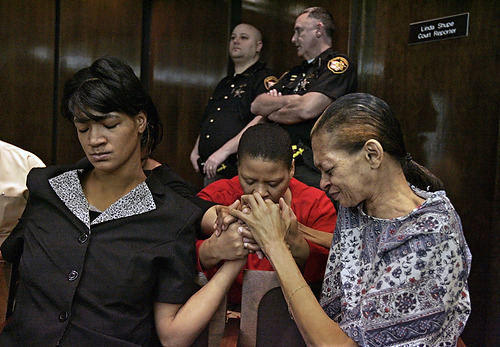 First Place, Feature Picture Story - Chris Russell / The Columbus DispatchAn angry LaDawnya Ruffin prays with her cousin Marilyn Gray and mother Karen Kelley while waiting for the judge to pass sentence on her son Melvin's killer.  Bryant Sebastian, 19,  was found guilty and sentenced to 18 years in prison.   A 17 year old boy was scheduled to be tried for the murder later in the year. 
