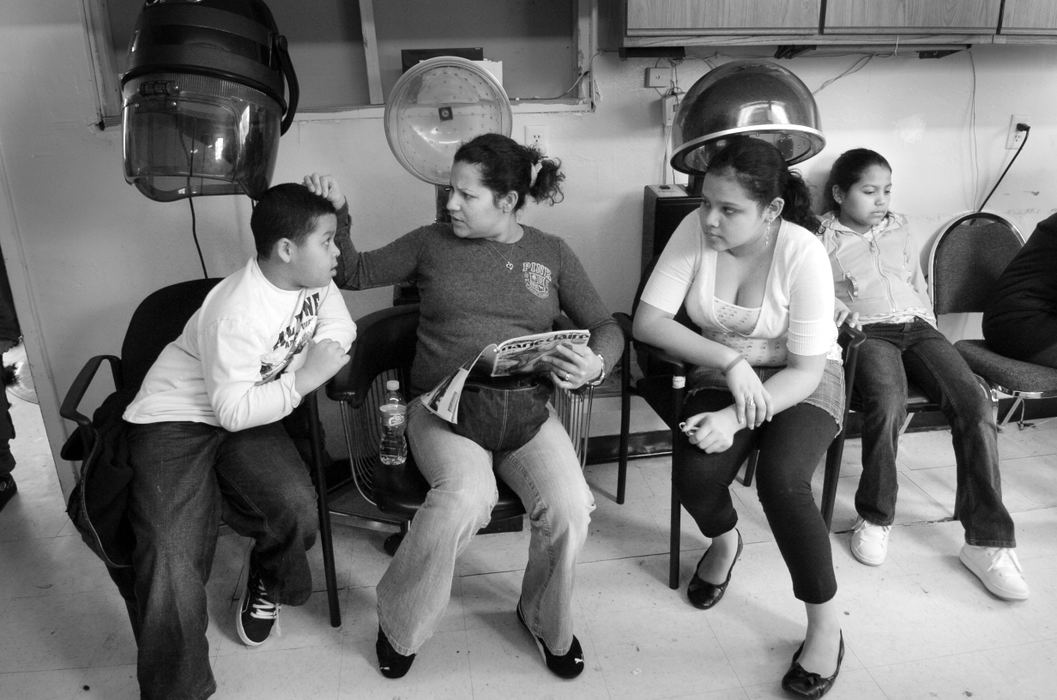 Third Place, Feature Picture Story - Carrie Cochran / The Cincinnati EnquirerFrom left: Danny Bolanos, 8, Maria Bolanos, 31, Maryory Crutcher, 14, and Andrea Crutcher, 12, all of West Chester, wait for Maria's to get her hair done at Cuba's Barbershop in Hamilton, March 1, 2008. 