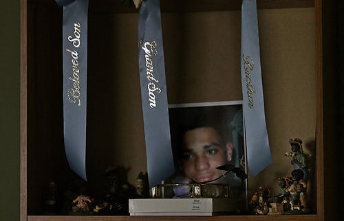 First Place, Feature Picture Story - Chris Russell / The Columbus DispatchA small shrine of blue ribbons and a photograph of Melvin are the last reminders of him at his mother's home.  The police believe that the killing was gang related, but could not prove it.  Blue is the color used by the Crips gang in Columbus.  