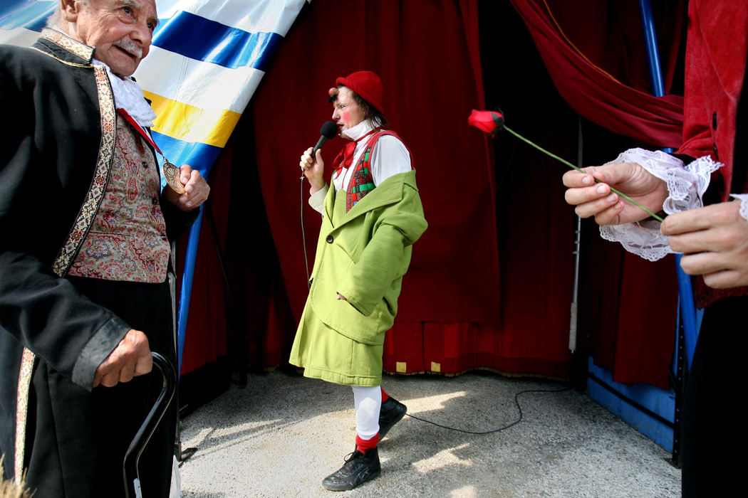 Award of Excellence, Feature Picture Story - Lisa DeJong / The Plain DealerGiovanni Zoppe (center) says hello to the crowd backstage at the Italian American Festival in Canton. Giovanni, who performs as the clown "Nino", is a sixth-generation circus performer who grew up in his family's circus. The Zoppe Family Circus started in Italy in 1842 and was brought to the United States by his father Alberto Zoppe, left. Alberto appeared in Cecil B. DeMille's film "The Greatest Show on Earth" as a circus performer. 