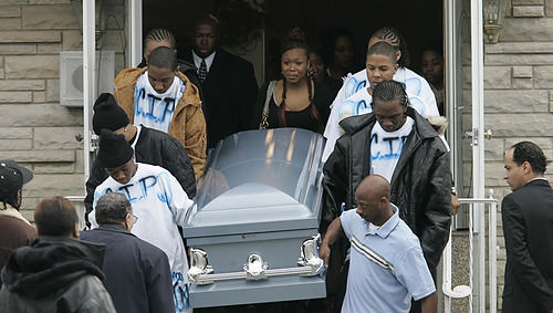 First Place, Feature Picture Story - Chris Russell / The Columbus DispatchMelvin's light blue casket is carried from the funeral home by pallbearers wearing custom made t-shirts bearing the letters C.I.P. that , according to Melvin's younger sister, stood for "Crip in Peace", but LaDawnya Ruffin insists that her son was not a gang member.