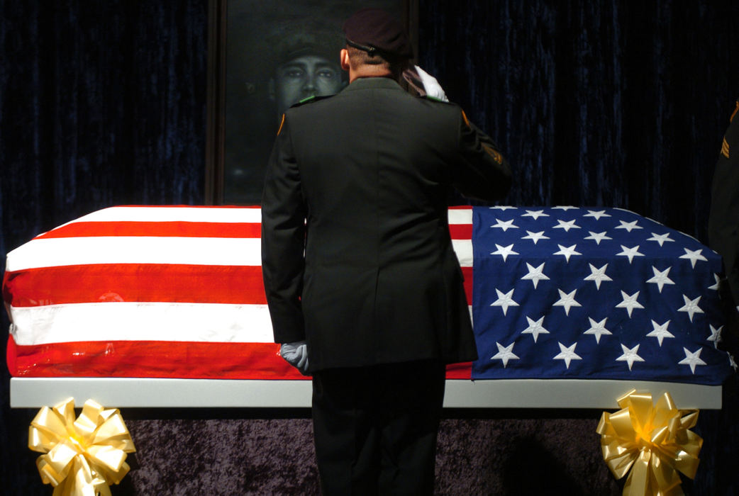 Second Place, General News - Carrie Cochran / Cincinnati EnquirerA member of the U.S. Army Honor Guard salutes U.S. Army Reserve Staff Sgt. Matt Maupin, April 26, 2008 during the changing of the guard at the Union Township Civic Center in Union Township. Maupin was part of the U.S. Army’s 724th Transportation Company and a graduate of Glen Este High School. Maupin arrived in Kuwait on Feb. 20, 2004. He was captured by Iraqi insurgents in Baghdad on April 9, 2004. The family was told his remains had been found on March 30th.  