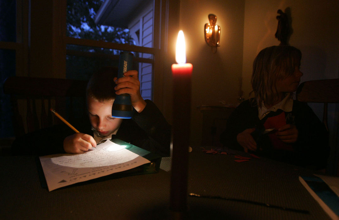 Third Place, General News - Joshua Gunter / The Plain DealerCandles help light the dining room at the Donsky home as eight-year-old Daniel Donsky  and sister, six-year-old Anna works on homework September 16, 2008 in Cleveland Heights. Patches of the west side are still without power.  