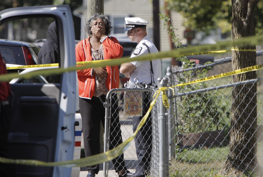 First Place, News Picture Story - Fred Squillante / The Columbus DispatchA woman mourns at the scene of the triple homicide.