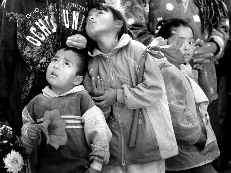 Second Place, News Picture Story - Carrie Cochran / Cincinnati EnquirerBells toll in honor of the four men as children crane their heads upward. The entire funeral lasted more than two hours. Christmas in Mexico is not just a time to honor the birth of Christ, but weddings, baptisms and quinceaneras are planned around the arrival of the migrant workers. This year's homecoming was bittersweet as the village en masse said goodbye to four of their own. 