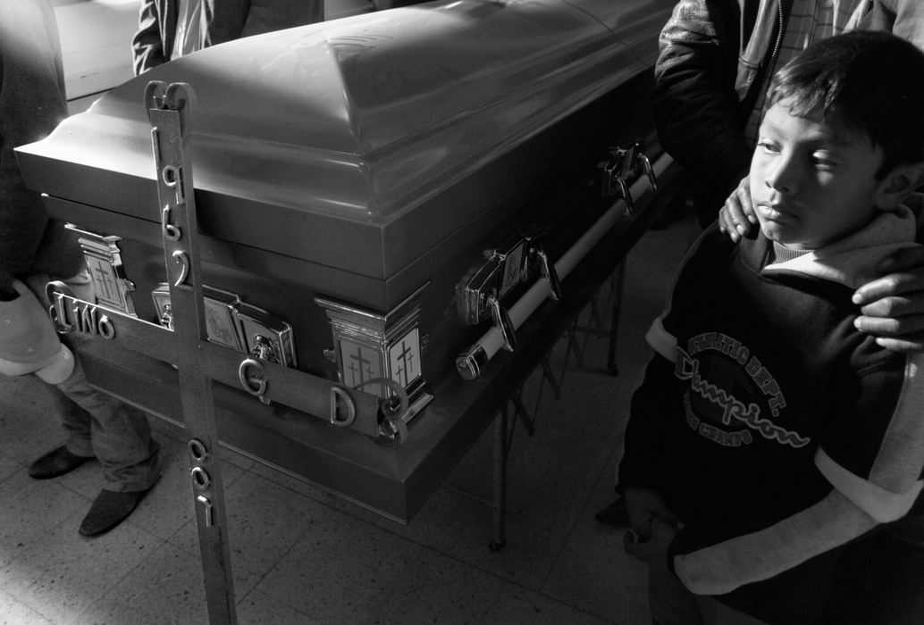 Second Place, News Picture Story - Carrie Cochran / Cincinnati EnquirerJose Mauricio, 8, stands beside the casket of his father, Lino Guardado Davila, 45. In the days leading up to his father's funeral, Jose Mauricio family said he believed his father is speaking to him and tells him to study hard.  