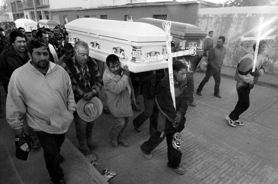 Second Place, News Picture Story - Carrie Cochran / Cincinnati EnquirerMore than a thousand people march through the streets of El Zacaton, trailing the caskets of the four men killed in Sharonville in December 2007, Lino Guardado Davila, 45, Conrado Lopez Guardado, 20, Manuel Davila Duenas, 31 and his brother Jose de Jesus , 21. Close to a month after they were killed, their bodies finally returned to Villa de Ramos. Their family believes that because they were working in the U.S. illegally, law enforcement agencies will not work to solve the crime.