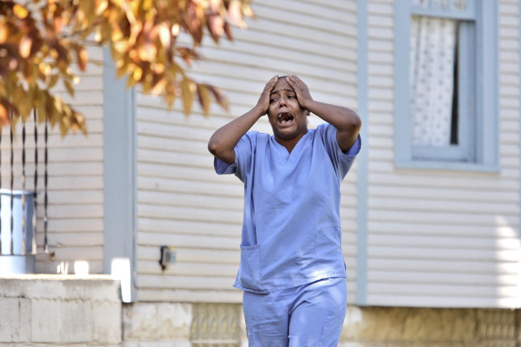 First Place, News Picture Story - Fred Squillante / The Columbus DispatchA woman mourns after arriving at the scene of three killings on Fairmont Avenue. 