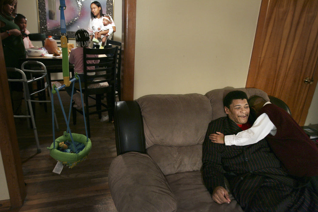 Third Place, News Picture Story - Shari Lewis / The Columbus DispatchRobert McClendon gets a hug from his grandson Ronnie Vaughn, 7, while taking a break from dinner at his daughter's house.