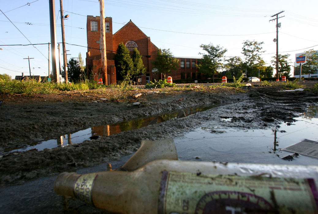 Award of Excellence, News Picture Story - Tracy Boulian / The Plain DealerWith foreclosures, crime, and drugs rampant in the eastern part of the city, churches that once thrived in these once more affluent areas are struggling to survive.  An alcohol bottle litters the empty lot across the street from Emmanuel Baptist Church. While some of the churches have fled the city for the suburbs, Emmanuel has continued to remain at E79th and Quincy through the changes in the neighborhood. 