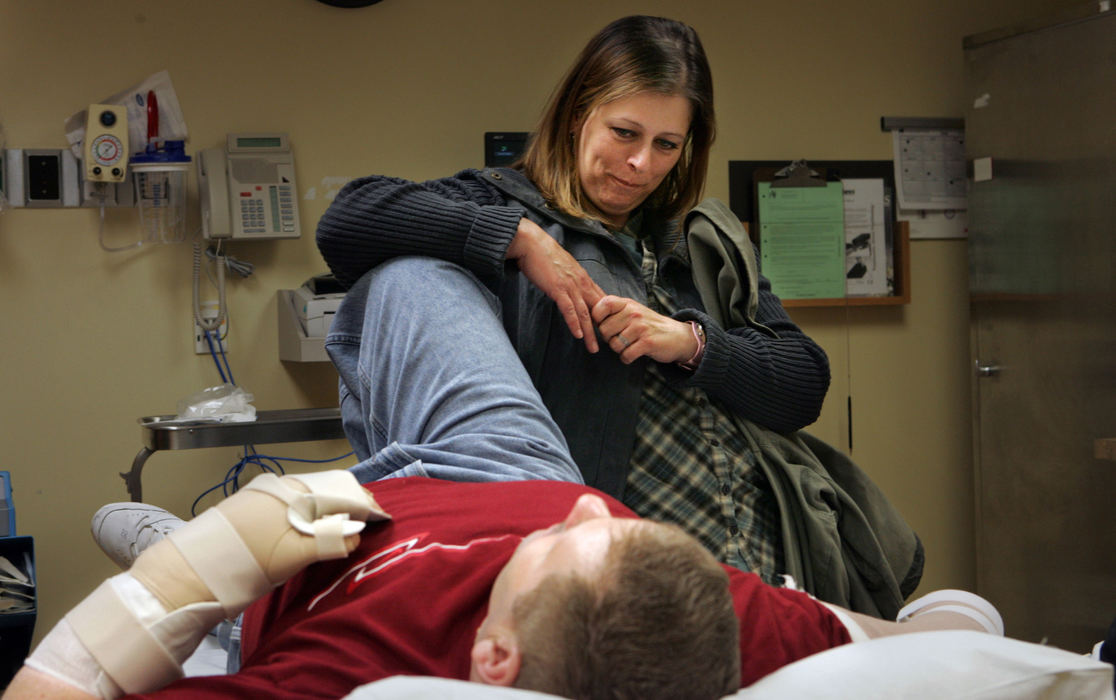 Third Place, Photographer of the Year - Gus Chan / The Plain DealerJeanie Martin leans on Norm as the two wait for the succession of therapists and doctors to come through to examine Norm.