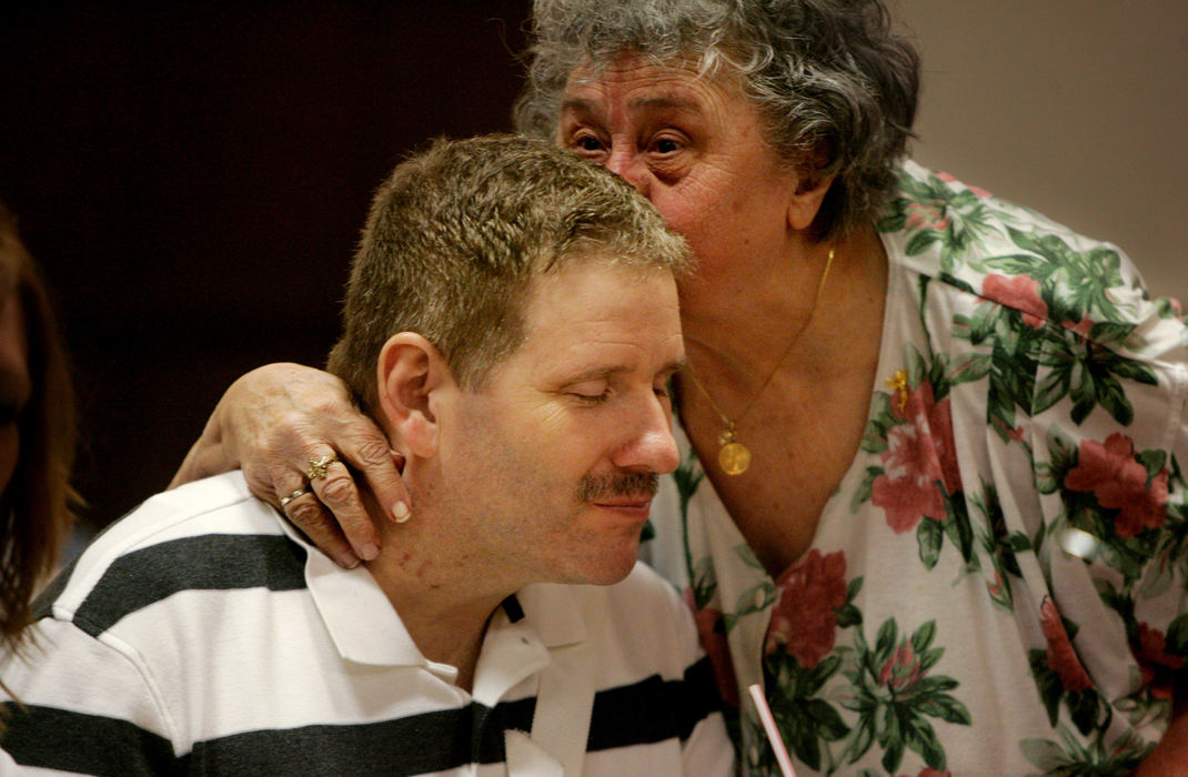 Third Place, Photographer of the Year - Gus Chan / The Plain Dealer Norm Martin gets a kiss from Josie Turner, Jeanie's great aunt at the fundraiser.