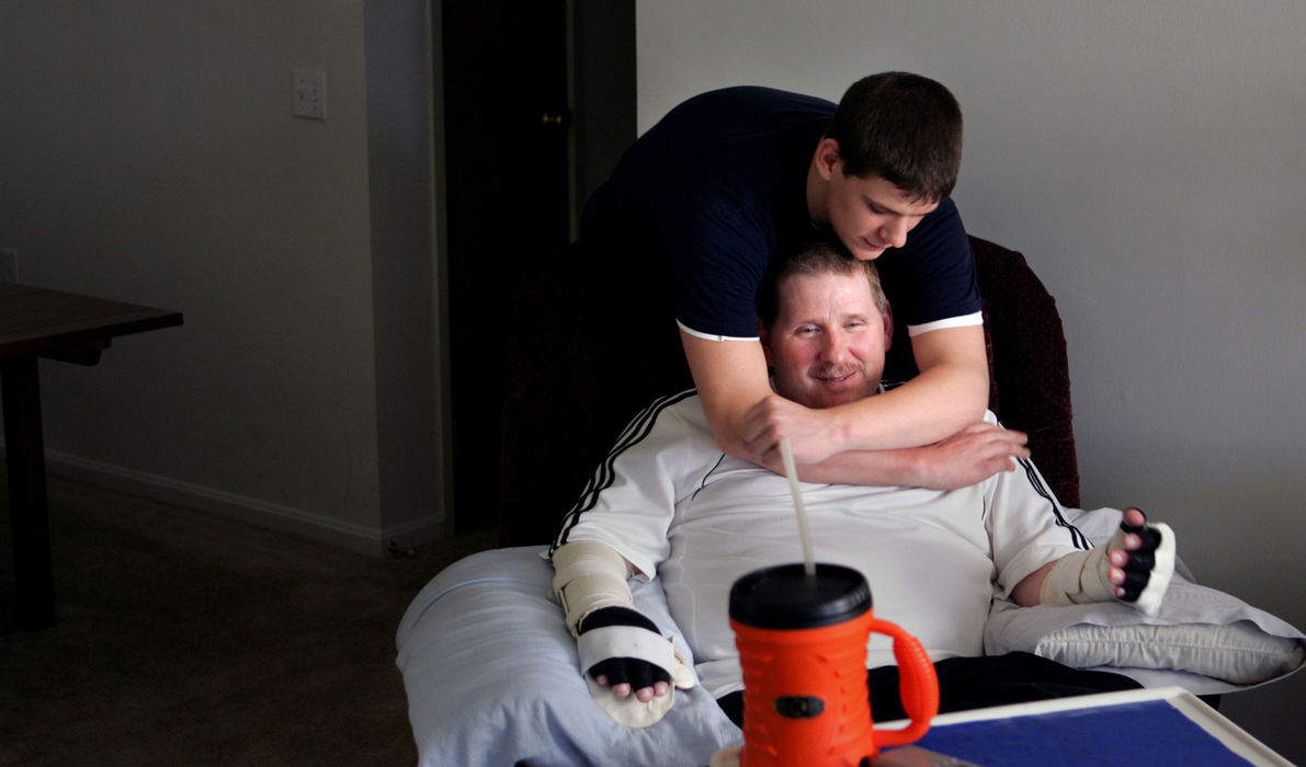 Third Place, Photographer of the Year - Gus Chan / The Plain DealerJake Martin gives a hug to his father, Norm, after coming home after a day at school.