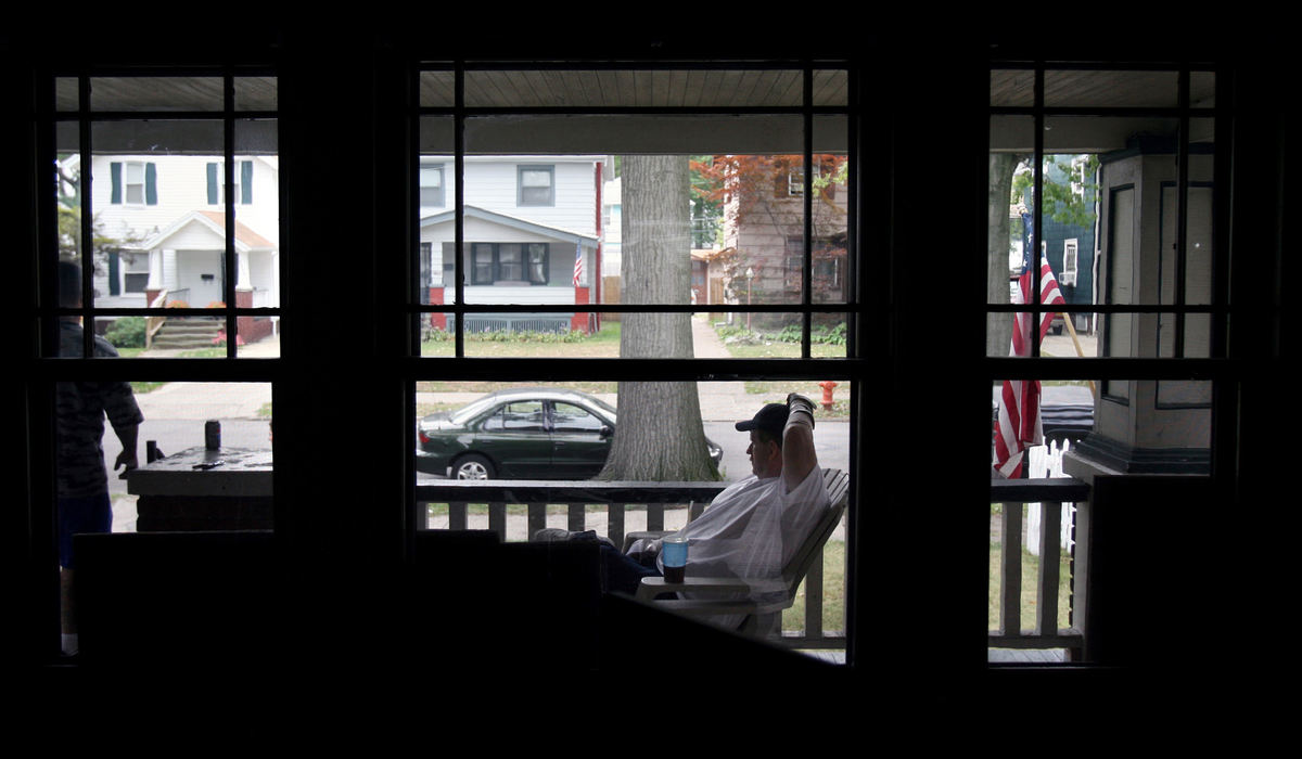 Third Place, Photographer of the Year - Gus Chan / The Plain DealerNorm Martin sits on his porch as he watches family members move him out of his home.  Martin short sold his home and moved into an apartment in Strongsville.