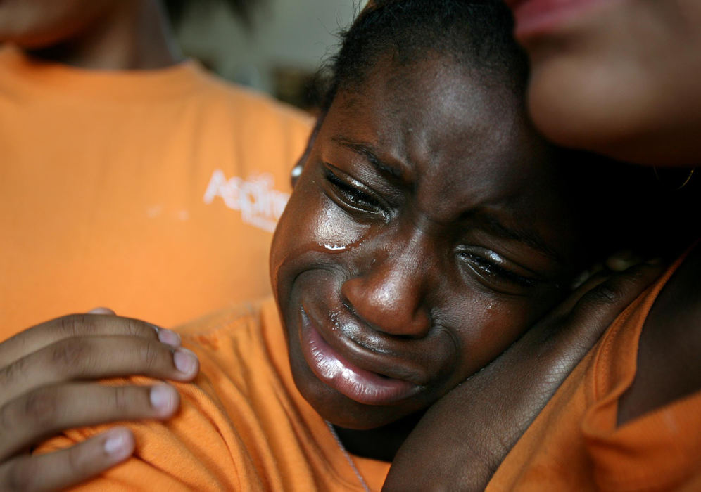 First Place, Photographer of the Year - Lisa DeJong / The Plain DealerMariane Tere, 10, hates to see the last day of the Aspire Program end as she clutches one of her new best friends Ashley Braxton, 10, (only chin showing on right) in a tearful goodbye at Hathaway Brown School. The Aspire Program is a tuition-free academic and leadership program that targets high-achieving girls in under-resourced public schools. At Aspire, these girls are mentored by high school and college students  whose teaching talent is being cultivated for future schools. 