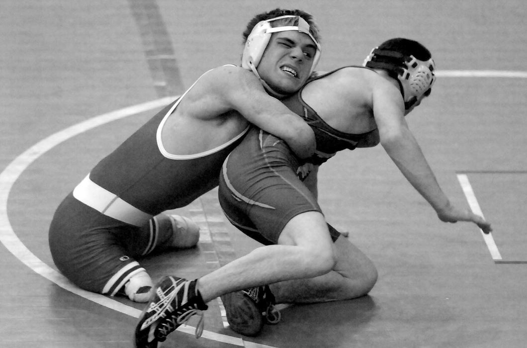 Second Place, Photographer of the Year - Michael E. Keating / Cincinnati EnquirerDustin Carter uses his legs and lower body strength to flip an opponent during a win in a qualifying meet on the regional level.