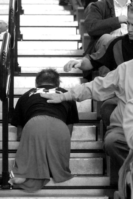 Second Place, Photographer of the Year - Michael E. Keating / Cincinnati EnquirerMaking his way back to the bleachers to sit with his girlfriend, Dustin Carter is patted on the back by people he passes on the steps after a match win.