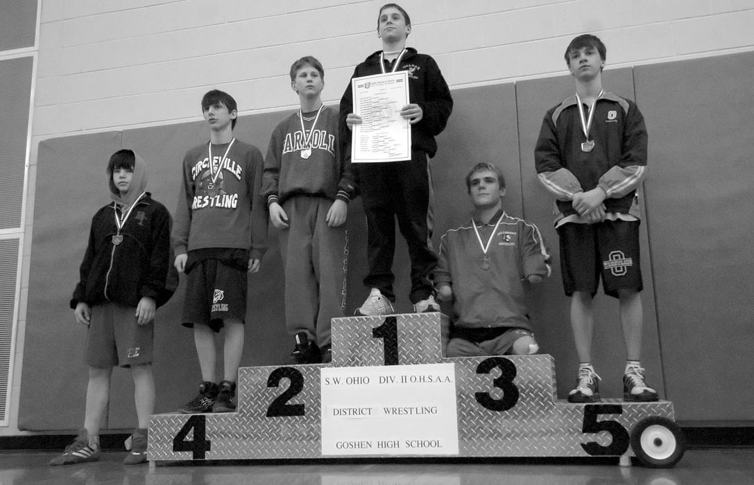 Second Place, Photographer of the Year - Michael E. Keating / Cincinnati EnquirerDustin Carter takes his place on the medal stand. A win here enabled him to go to the state finals in Columbus, Ohio.