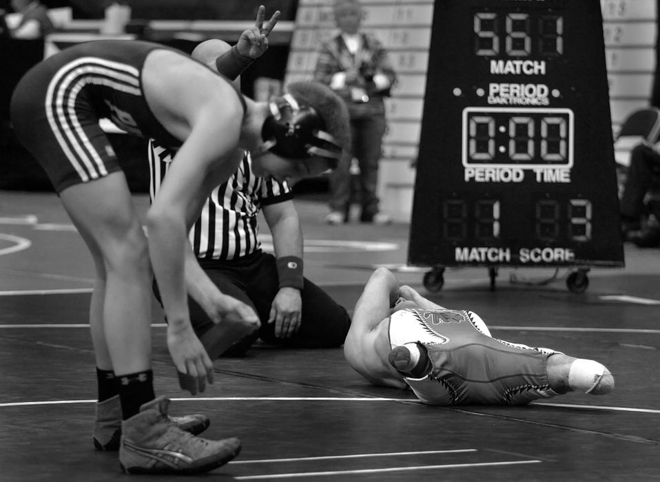 Second Place, Photographer of the Year - Michael E. Keating / Cincinnati EnquirerDustin Carter lies on the mat after losing in a qualifying round at the state tournament. A second loss, later in the day eliminated him from the tournament.