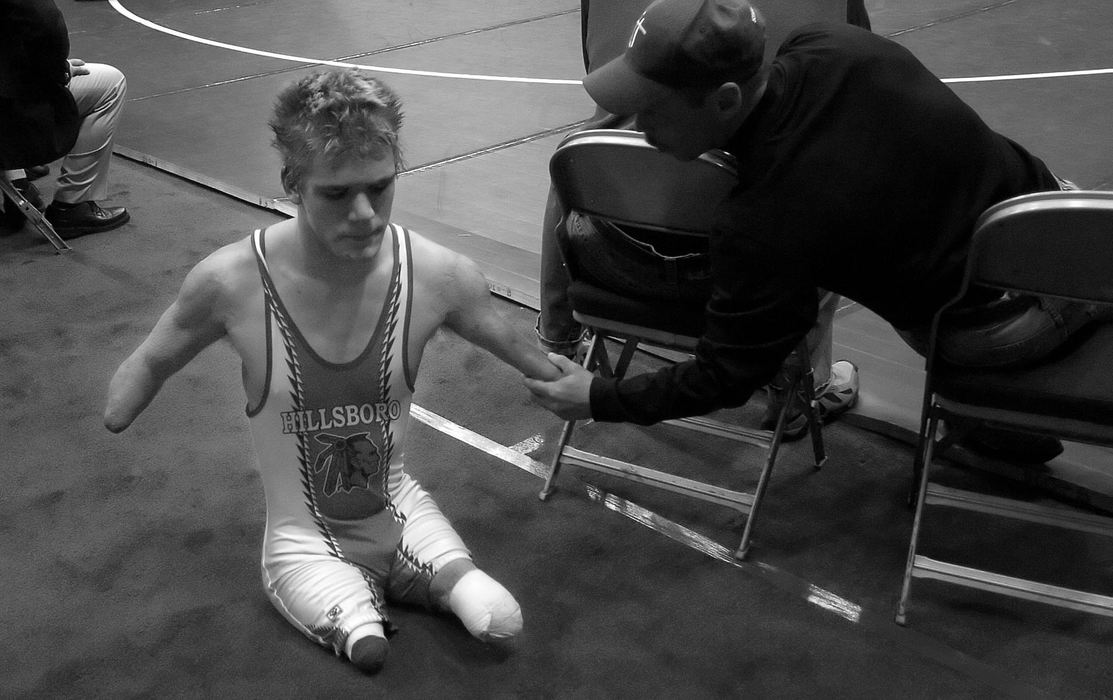 Second Place, Photographer of the Year - Michael E. Keating / Cincinnati EnquirerAn opposing coach reaches out to shake the stump of Dustin Carter after he was defeated and left the wrestling mat.