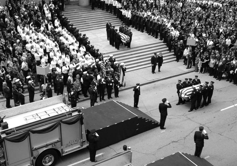 Second Place, Photographer of the Year - Michael E. Keating / Cincinnati EnquirerFlag draped caskets carried from the church will be placed on the fire trucks for transport to the cemetery.Friends and family lined the steps outside the church.