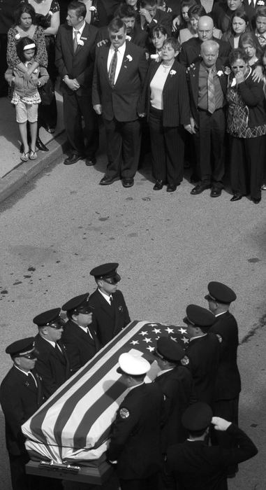 Second Place, Photographer of the Year - Michael E. Keating / Cincinnati EnquirerFamily and friends hold back emotions as one of two caskets is carried past them and on to a waiting fire truck. 