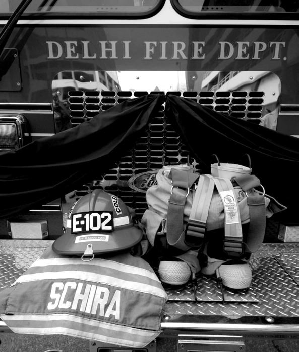 Second Place, Photographer of the Year - Michael E. Keating / Cincinnati EnquirerThe turnout gear of Brian Schira on the front bumper of the truck carrying him to his grave. 