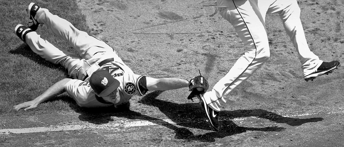 Second Place, Photographer of the Year - Michael E. Keating / Cincinnati EnquirerWashington Nationals pitcher Colin Balester falls to the ground and reaches tag out Edwin Encarnacion as he attempted a bunt.