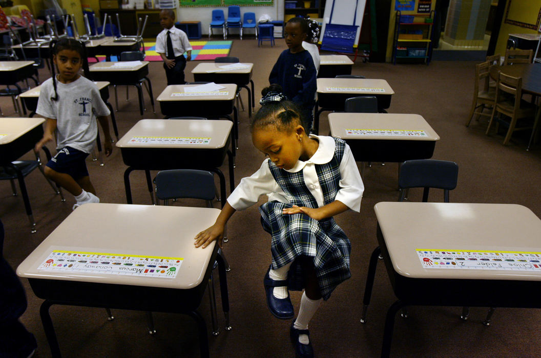Third Place, Photographer of the Year - Gus Chan / The Plain DealerChloe Felder, a first graders at St. Francis School does her morning exercises before sitting down to do her school work August 28, 2008.  St. Francis school  is one of the anchors that support the E. 71 St. community.  St. Francis School, which relies heavily on school vouchers to keep it's doors open, will not close with the latest school restructuring plan. (Gus Chan / The Plain Dealer)