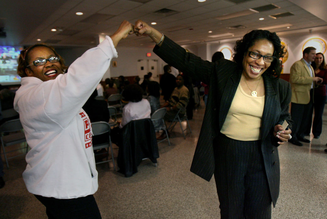 Third Place, Photographer of the Year - Gus Chan / The Plain DealerMarcia Fudge fist bumps supporter Elona White (left) during Fudge's victory party. Fudge was elected to to the 11th Congressional District, taking the seat of Stephanie Tubbs Jones, who died suddenly from a brain aneurysm.