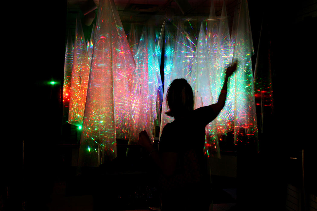 Third Place, Photographer of the Year - Gus Chan / The Plain DealerSpectators walk into an exhibit called Convolutions at the Ingenuity Festival.  The display uses fiber optics and holographic imagery.  The Ingenuity Festival focuses on merging art with technology.