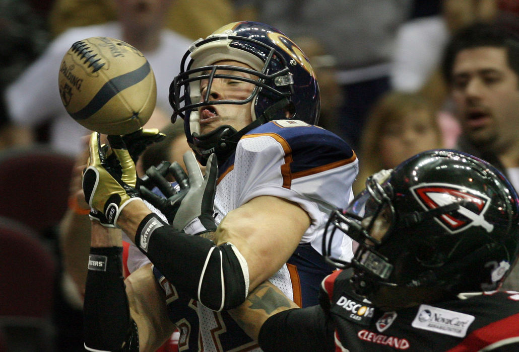 Third Place, Photographer of the Year - Gus Chan / The Plain DealerCrush wide receiver Ben Nelson has the ball knocked away from him by Gladiators defensive back Alex Teems in an Arena Football League game.