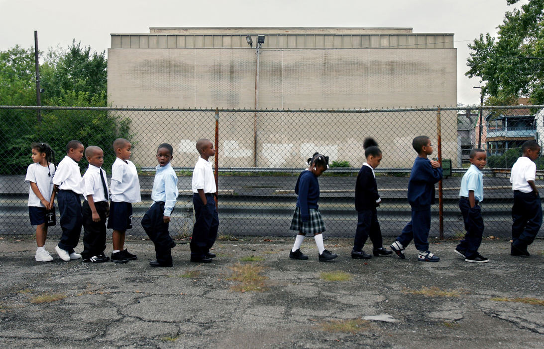 Third Place, Photographer of the Year - Gus Chan / The Plain DealerFirst graders at St. Francis School make their way back into the school after being shown where to go in the event of a fire drill, August 28, 2008.  St. Francis school  is one of the anchors that support the E. 71 St. community. 