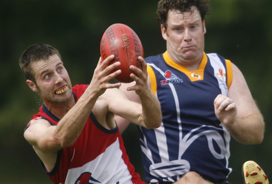 First Place, Sports Action - Andrea Kjerrumgaard / ThisWeek NewspapersColumbus Jackaroos' Chet Ridenour reaches to catch a ball over the defense of the Ohio Valley River Cats' Matt Seuling during the Jackaroos first home game of Australian Rules Football, September 13, 2008, at Tuttle Park.  