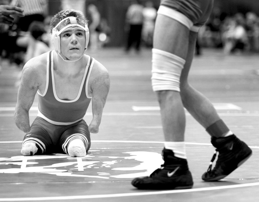 First Place, Sports Feature - Andy Morrison / The BladeHillsboro's Dustin Carter (left) squares off against Andrew Bertubin of Cambridge during their Division II 103-pound championship preliminaries at the 71st Annual State Wrestling Tournament in Columbus. Carter, who had parts of all of his limbs amputated due to a bacterial infection in his bloodstream at age 5, won the match.