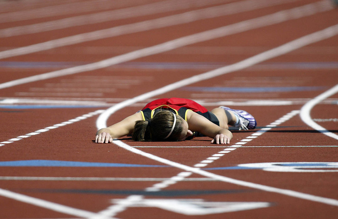 Award of Excellence, Sports Feature - Adam Cairns / ThisWeek NewspapersColumbus School for Girls' Clare Connor collapses to the track after completing the 400-meter dash during the state track meet preliminaries at Ohio State's Jesse Owens Stadium on June 6. Gusty winds and temperatures in the 90s posed problems for many runners.