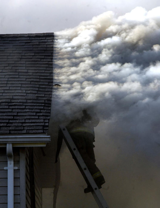 Second Place, Spot News under 100,000 - Marshall Gorby / Springfield News-SunSpringfield firefighters work to extinguish a blaze at 1413 West Perrin Avenue, Oct. 22, 2008 in Springfield. Two people were inside the home when the fire started and both escaped without injuries. The fire reportedly started in the garage, sending up columns of smoke that were visible for miles. 